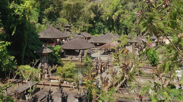Aerial view of Pura Gunung Kawi Sebatu temple surrounded by lush tropical forest and traditional Balinese buildings in Ubud
