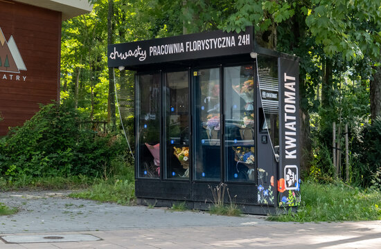 Black flower vending machine kwiatomat with glass compartments holding bouquets