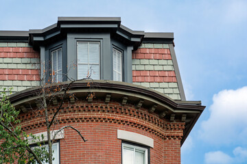 Polychrome slate mansard roof on a classic brick row house in the South End of Boston © Baharlou