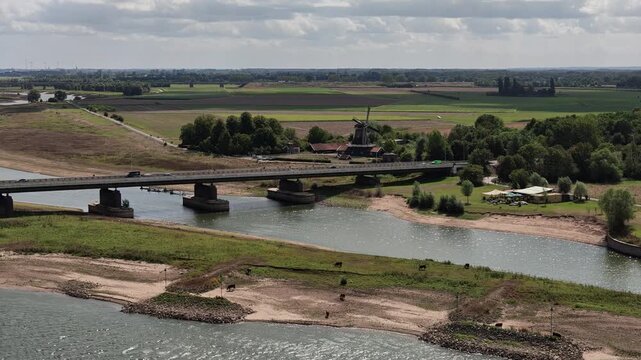Scenic perspective over IJssel river water and green shoreline in Deventer
