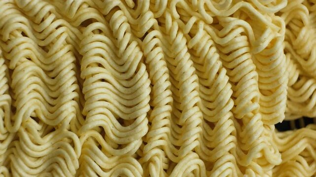 Extreme macro top view of raw instant ramen noodle texture slowly rotating
