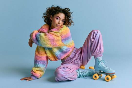 Stylish Young Woman in Colorful Jacket Wearing Roller Skates