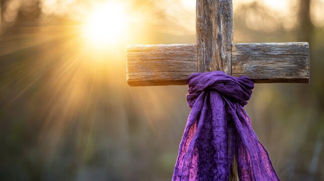 A rustic wooden cross draped with purple cloth stands silhouetted against a sunlit background, symbolizing Good Friday