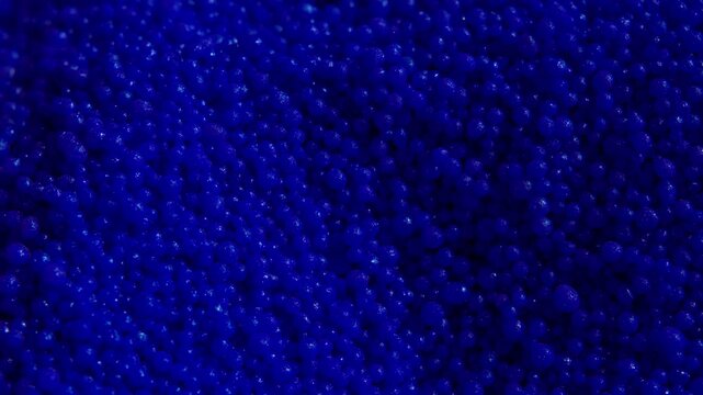 Macro view of many blue plastic particles , abstract raw material background