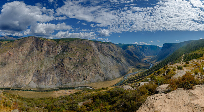 Majestic canyon landscape with river and cloud-filled sky Katu Yaryk pass Altay