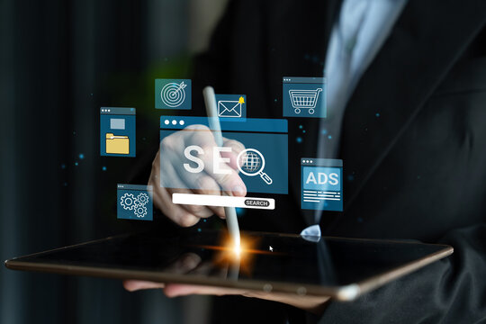 Business Professional Engaging in Digital Marketing Strategies Using Touchscreen Technology with SEO and Ads Icons in Background. Entropy.
