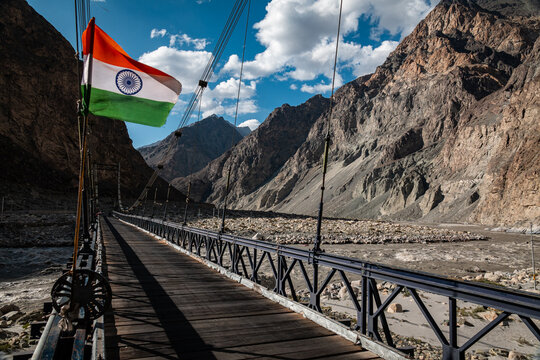 Suspension bridge with Indian flag in a Ladakh mountain valley
