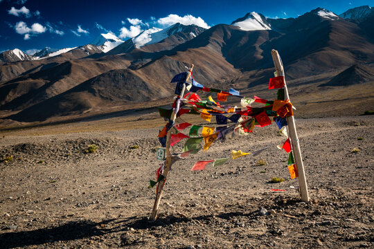 Colorful prayer flags on a barren mountain plateau in Ladakh