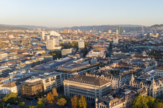 Aerial drone shot flying above Lake Zurich, Switzerland in sunny day. Beautiful landscape of a large magnificent lake and natural mountain scenery that popular place in summer in the city of Zurich.