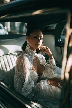 Stylish bride sitting in a vintage car after the wedding ceremony, elegant dress details, nostalgic luxury mood