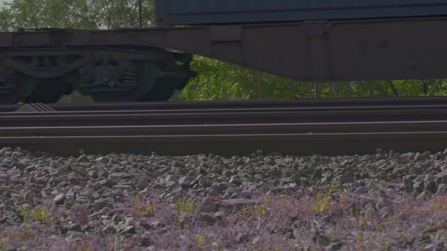 Freight train wheels rolling on railway tracks