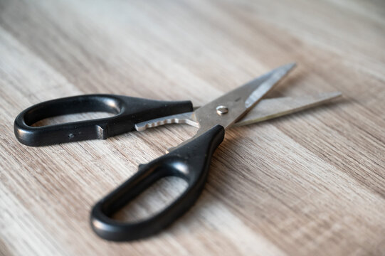 Scissors with black plastic handles on a table