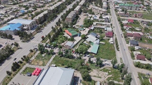 Aerial drone view focusing on Dungan Mosque among Soviet-era residential buildings in Karakol, Kyrgyzstan