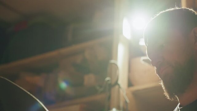 Skilled joiner examines detailed woodwork focusing intently as man inspects craftsmanship of handcrafted items. warm lighting highlights his concentrated expression and tools in workshop