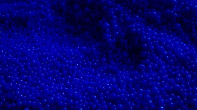 Close up of blue plastic pellets falling, showing raw material for injection molding. Great for petrochemical industry, polymer manufacturing, and modern science videos.