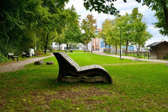 Modern wooden park lounger in green urban park Bad T&ouml;lz Germany for landscape architecture