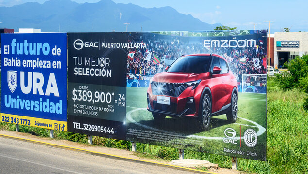 A road billboard with advertisements for URA and GAC vehicles