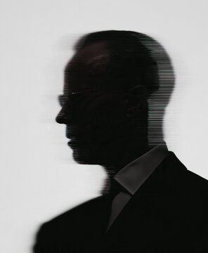 Glitched side profile silhouette of person wearing a dark suit