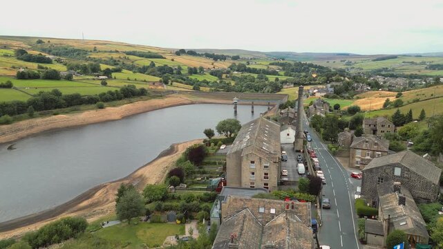 Aerial view of village near wide river. Leeming_Village, Halifax, West Yorkshire, Wind Farm, turbines,