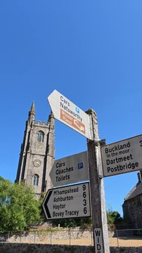 Widecombe in the Moor Devon England UK. 20.08.2026. Video, Signpost on village green showing local towns and villages  on datmoor national park
