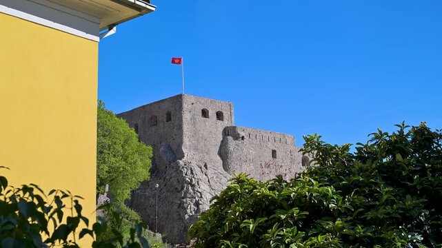Stone fortress with flag of Montenegro in Herceg Novi