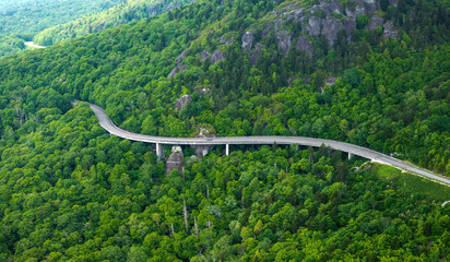 Obraz premium Blue Ridge Parkway road trip. Linn Cove Viaduct driving. Car exploration travel in summer forest on Appalachian mountain hills in North Carolina. Summertime landscape of beautiful nature