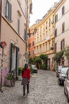 A Young Woman Walking Through a Quiet Traditional Alleyway in the Center of Rome