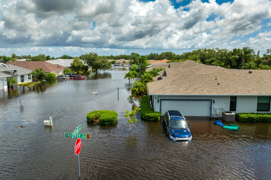 Hurricane Debby tropical rainstorm flooded residential homes and cars in suburban community in Sarasota, Florida. Aftermath of natural disaster