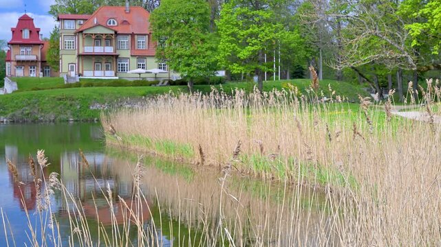 Historic building reflection on a moat with reeds in Saaremaa, Estonia