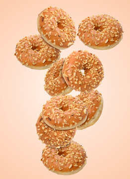 Dynamic composition of levitating caramel donuts with nut crumbs