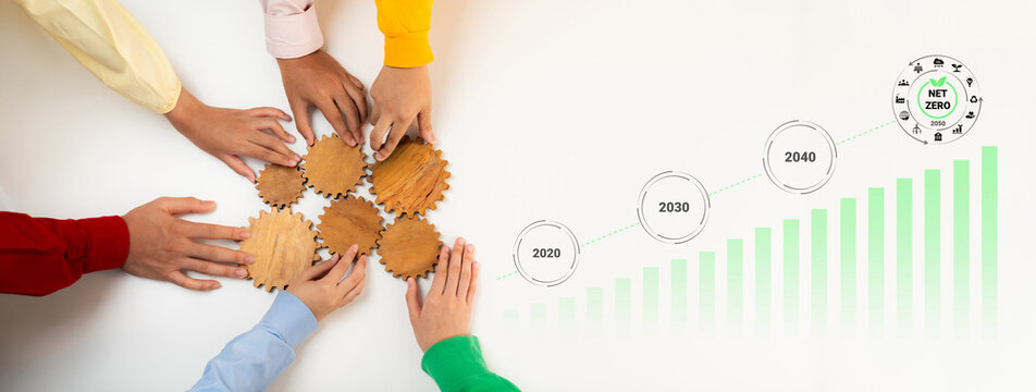 Diverse hands gather around wooden gears, illustrating collaboration. A growth chart and future markers emphasize the journey towards sustainability and reduction in emissions. Gantry