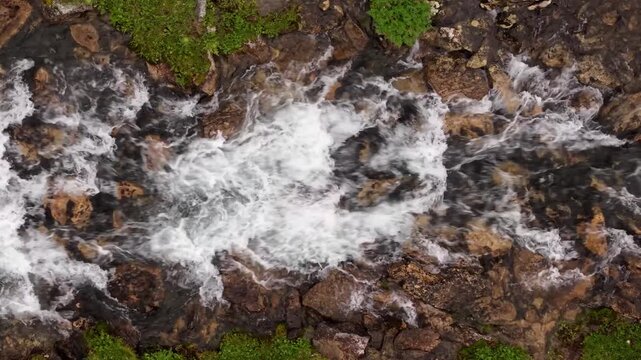 Rushing mountain stream flowing over rocky riverbed