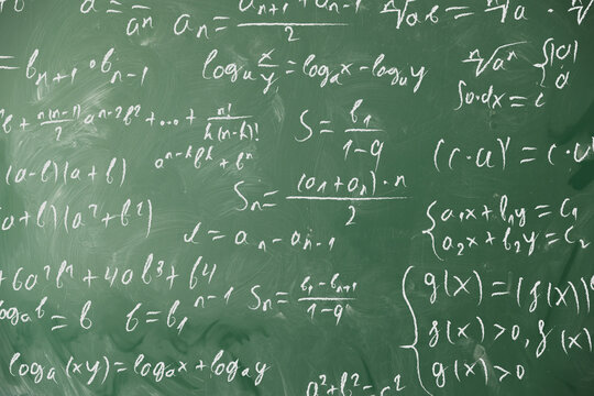 Chalkboard covered with mathematical equations as background