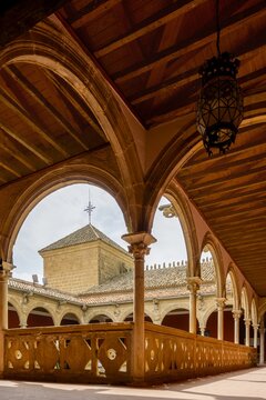 Casa de las Torres, a historic palace in Ubeda, Spain, showcasing an interior courtyard with intricate Plateresque arches, columns, and a traditional wooden ceiling, reflecting Renaissance grandeur