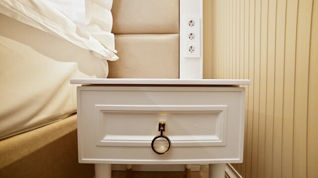 Camera zooms out from bedside table drawer in bedroom