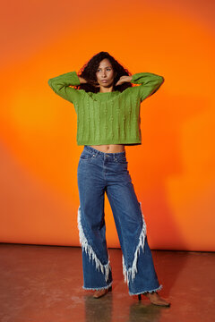 Captivating African American woman showcases vibrant fashion and style against a striking backdrop
