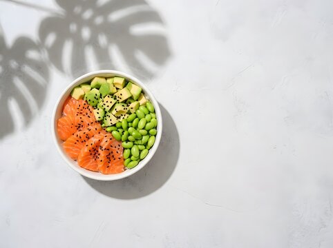 Fresh poke bowl with salmon, avocado, and edamame isolated on white background