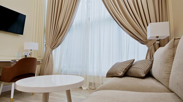 Modern hotel suite interior with sofa and desk