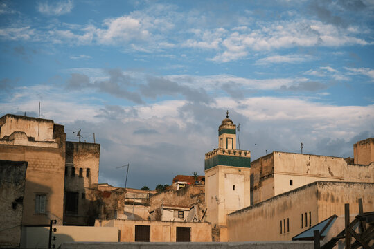 Historic Minaret and Rooftop Skyline Against Cloudy Sky in Fes Morocco 
