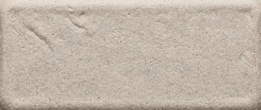 Recycled molded paper pulp packaging texture. Pressed beige cardboard fiber background. Eco friendly biodegradable material