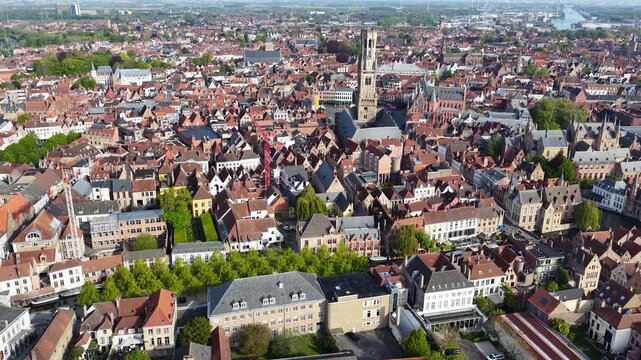 Aerial drone view of the old town of Bruges in Belgium, with the towers of the cathedrals of St. Salvator and St. Mary and the Belfry of the Market square in Bruges. Architecture of the medieval city.