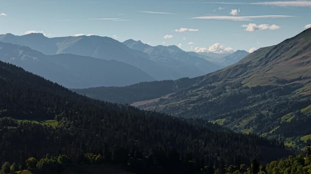 Wide mountain landscape with dense evergreen forests and valleys