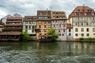 Obraz premium Charming historic half-timbered houses along the river in the Petite France district of Strasbourg, France.