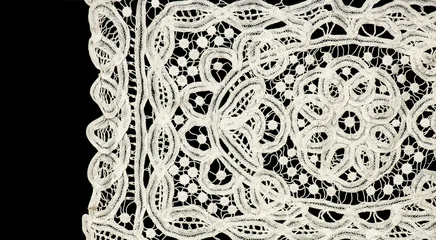 Ribbon lace tape isolated on black background, bobbin lace with gimp trim, vintage textile design, antique fabric art, doily. Border art vintage design © Subbotina Anna