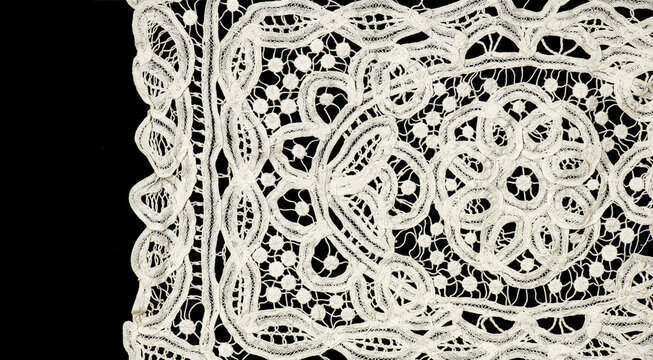 Ribbon lace tape isolated on black background, bobbin lace with gimp trim, vintage textile design, antique fabric art, doily. Border art vintage design