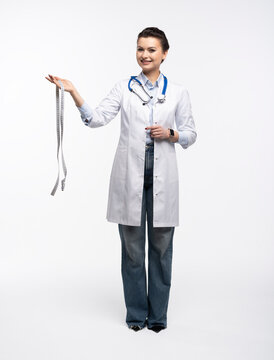 Portrait of pretty positive lady doctor with empty space blank isolated on white background.