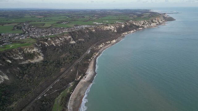 Workers build coastal defenses at East Wear Bay along Folkestones White Cliffs, protecting the railway and coastline from erosion.