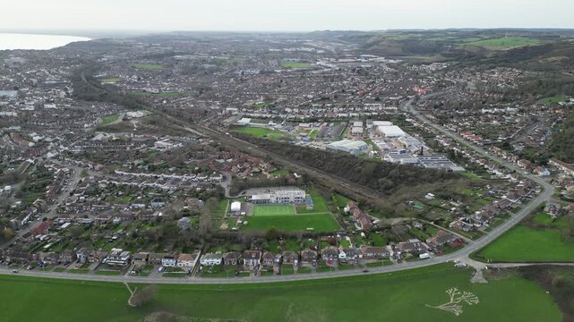 An aerial survey mapping Folkestone, UK, showcasing coastal neighborhoods, railways, and the North Downs to document local urban geography.