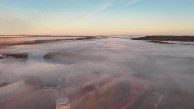 Flying above clouds with city and forest under