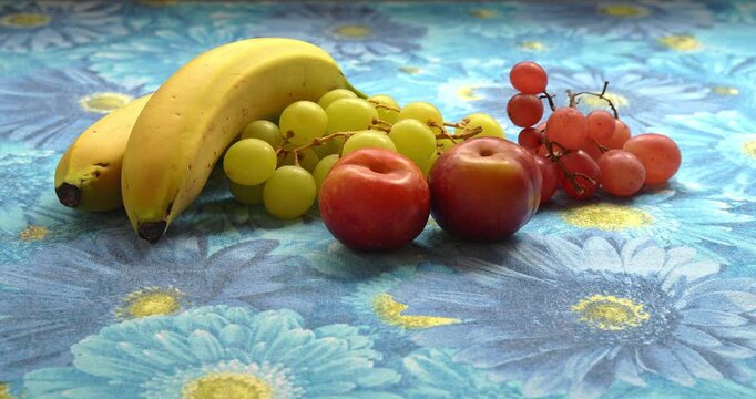 : Still Life - Fruit composition with bananas, plums, and grapes